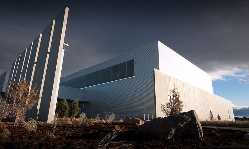 Modern white industrial building with vertical fins
